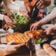 Group of young adult Asian Friends holiday party dinner at home around the table